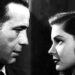 Here, Private Det., Phillip Marlowe (Humphrey Bogart) and his rich client’s pretty, eldest daughter, Vivian Rutledge (Lauren Bacall) size each other up and exchange double entendres in The Big Sleep (1946).